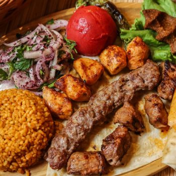 top-view-kebab-mix-with-bulgur-onion-pita-bread-with-vegetables-stand